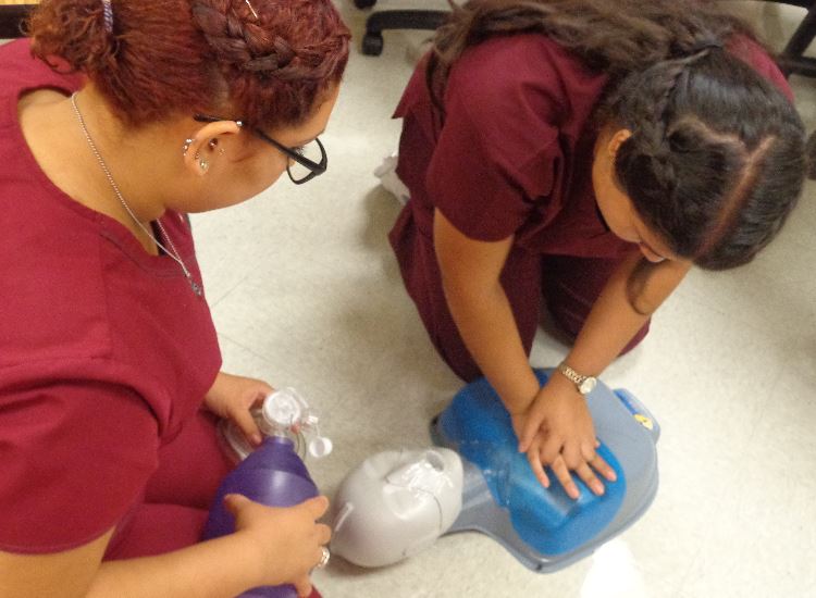 students performing first aid