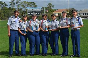 JROTC students holding a trophy 