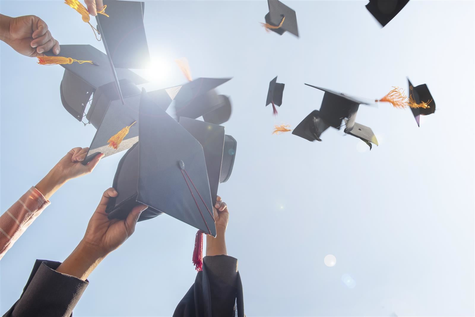 Graduation caps being tossed into the air