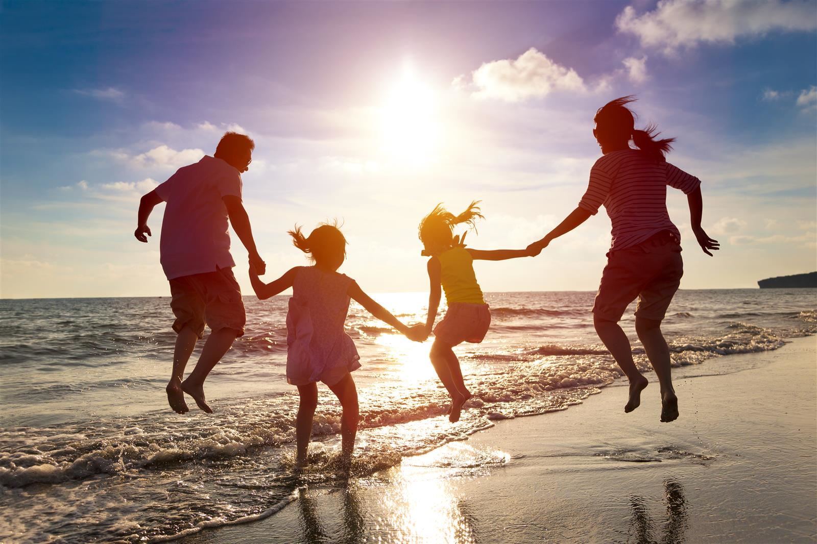 Family jumping in the air holding hands