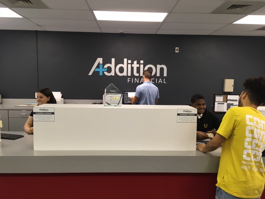 Students working at Addition Financial service desk.